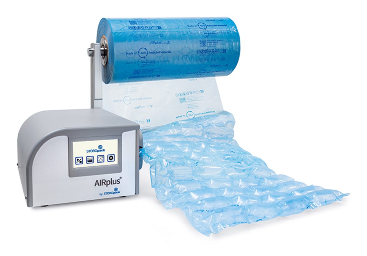 AIRplus air pillow machine with a touch screen, feeding a blue film roll into a chain of inflated air cushions